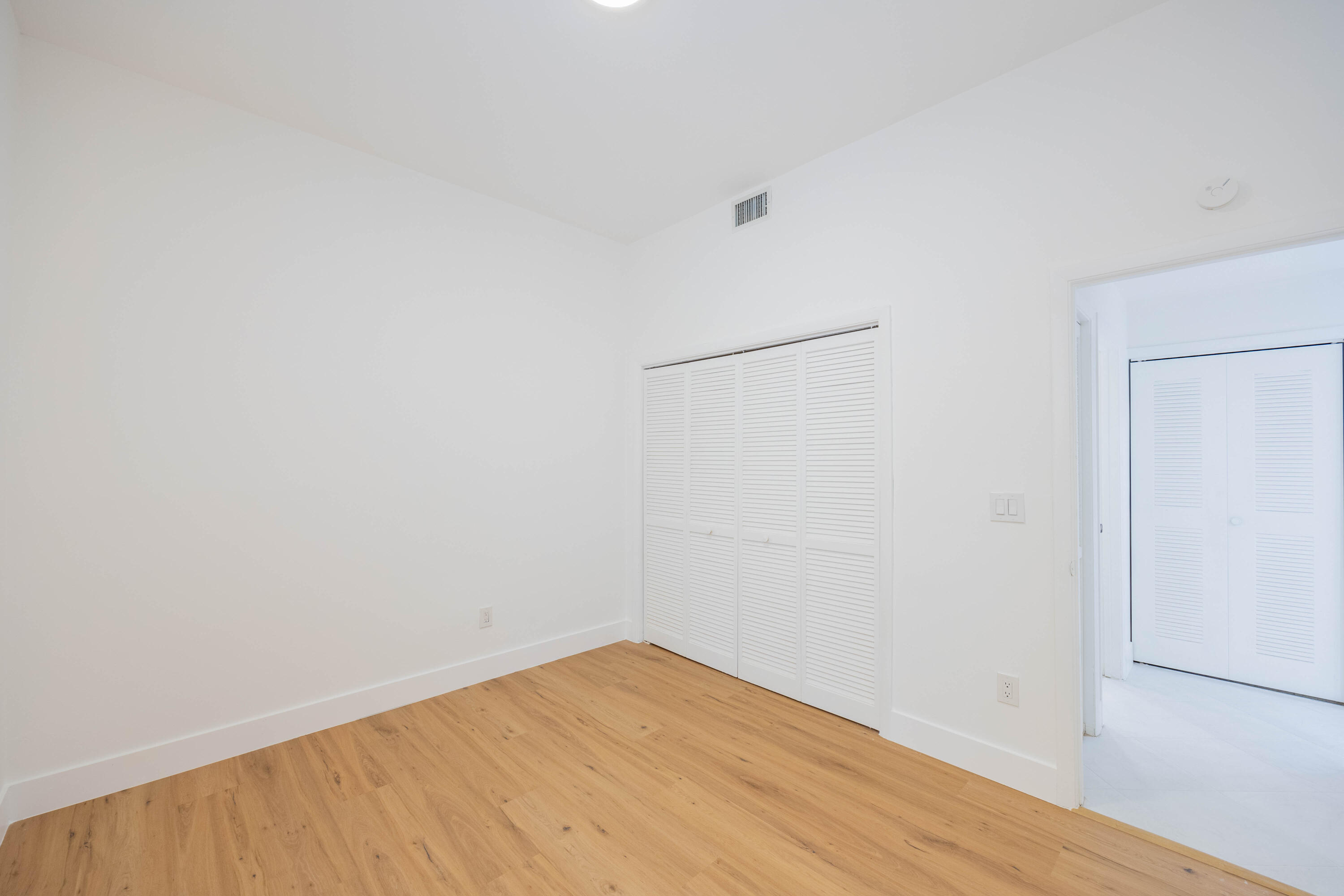 7520 La Paz Boulevard, Unit 104 Boca Raton, FL 33433 - Photo 34 of 56 a view of empty room with wooden floor