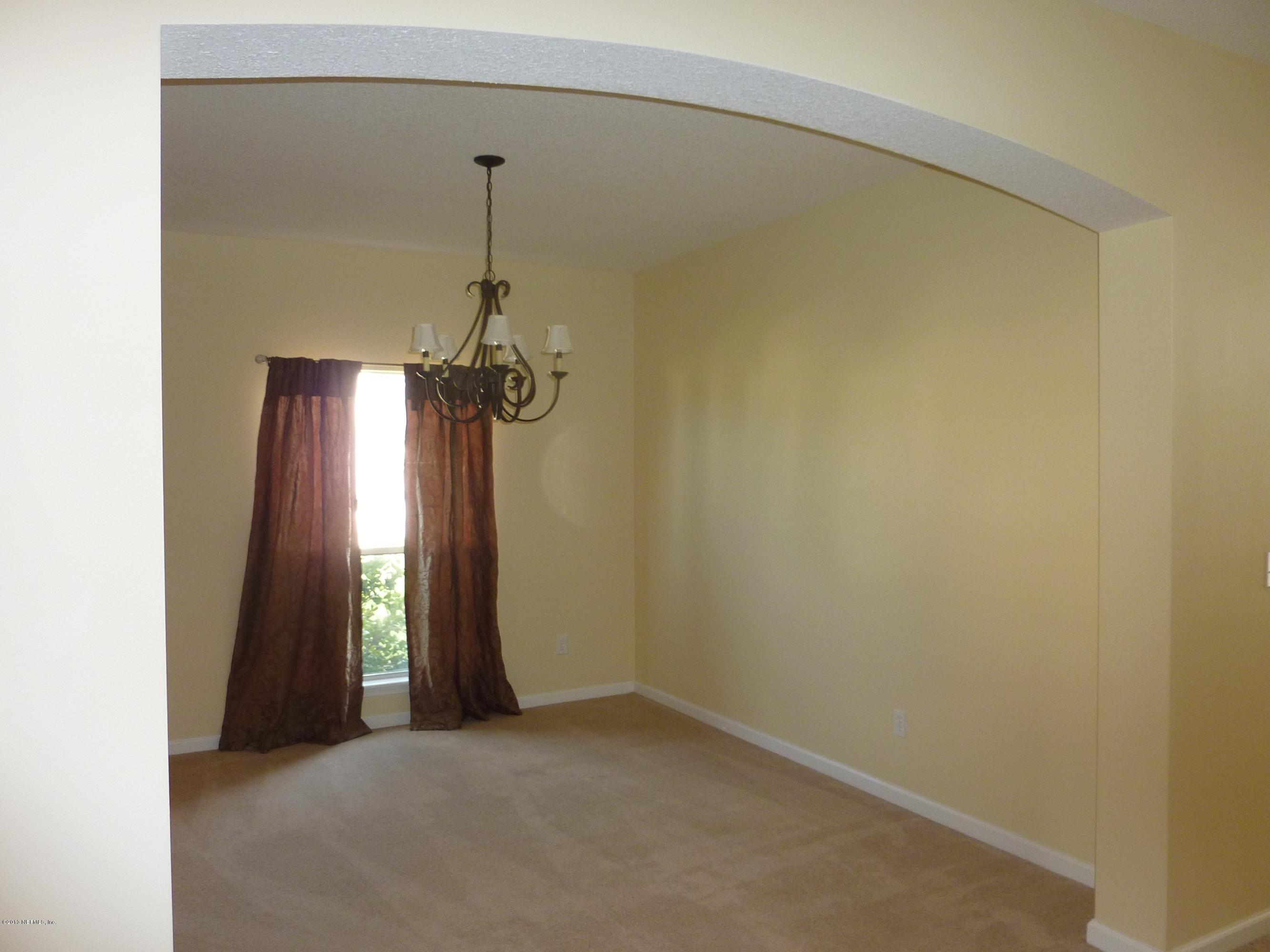 273 Porta Rosa Circle St. Augustine, FL 32092 - Photo 11 of 48 a view of a room with a hanging light and a window