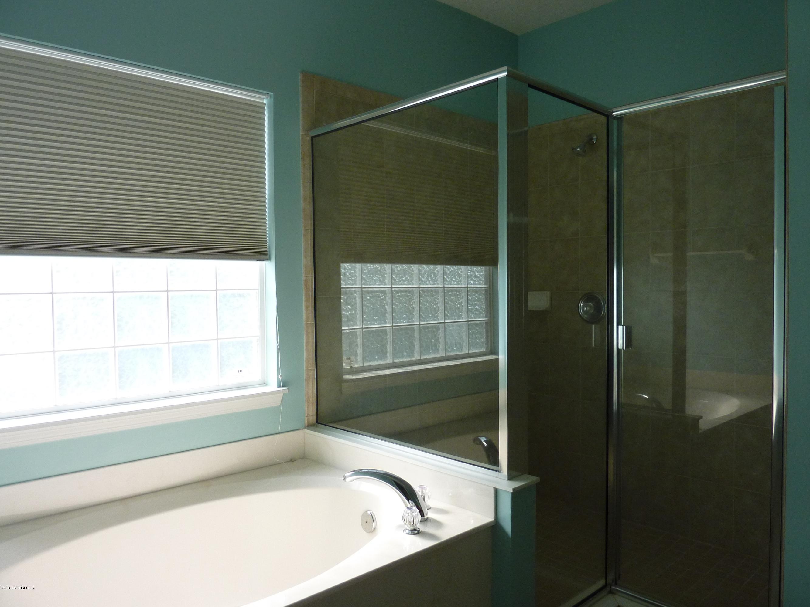 273 Porta Rosa Circle St. Augustine, FL 32092 - Photo 15 of 48 a bathroom with a shower and a bathtub