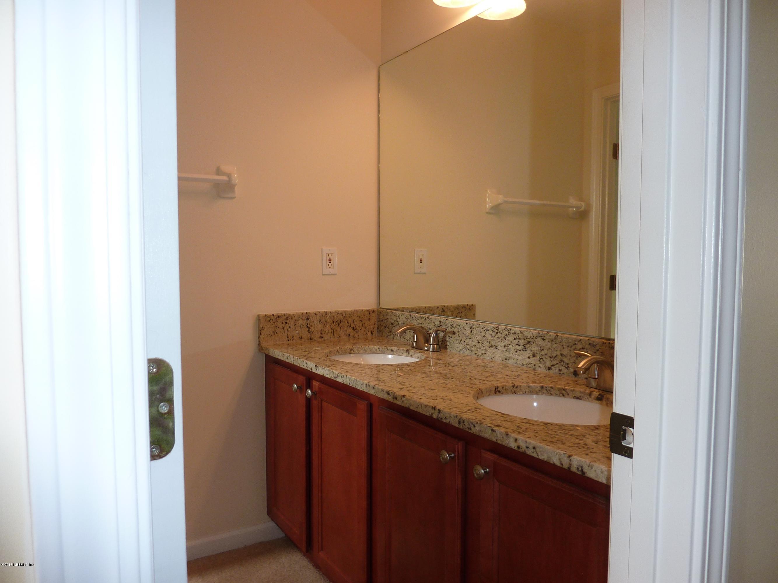 273 Porta Rosa Circle St. Augustine, FL 32092 - Photo 19 of 48 a bathroom with a granite countertop sink and a mirror