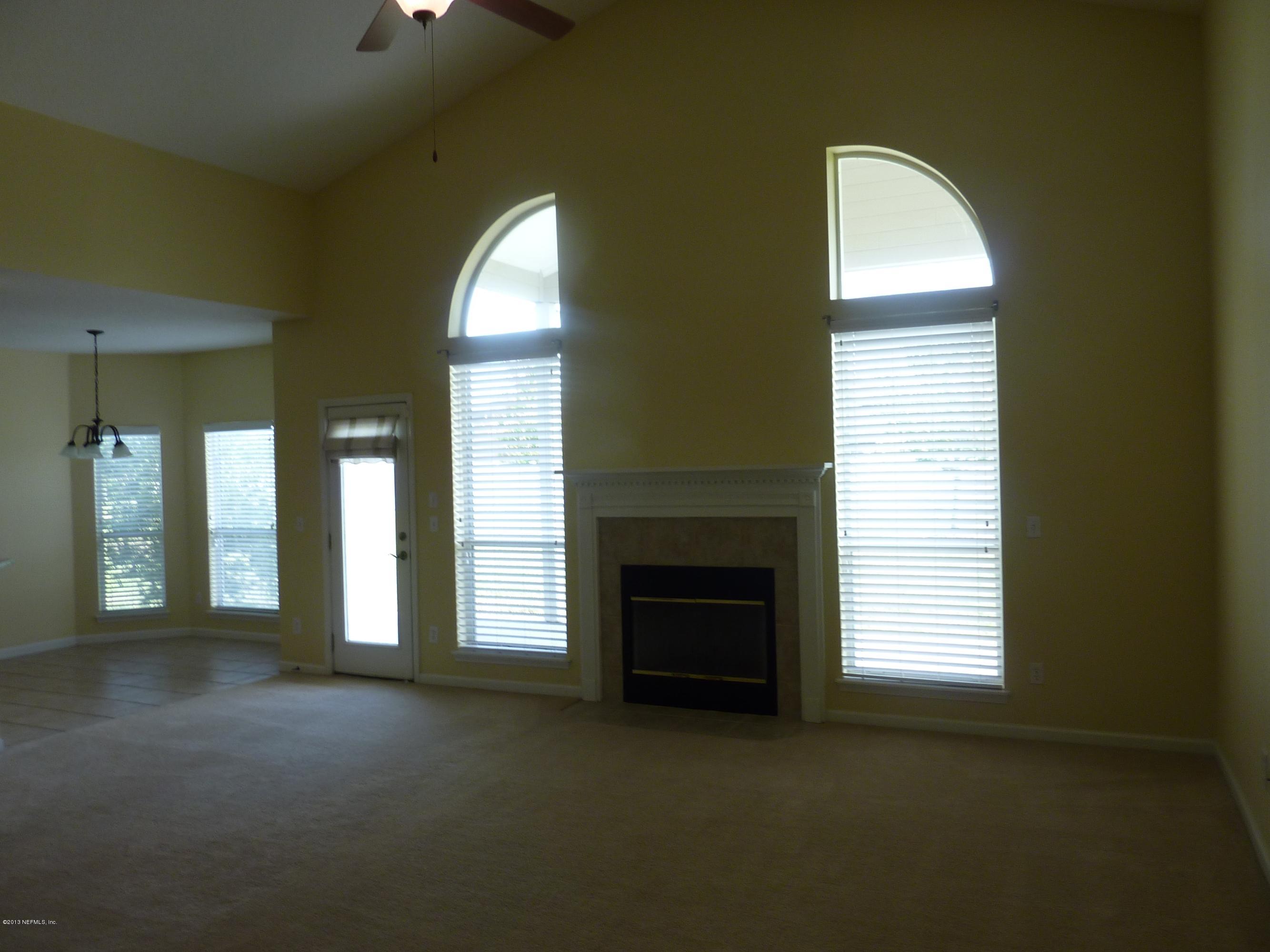 273 Porta Rosa Circle St. Augustine, FL 32092 - Photo 6 of 48 a view of an empty room with a fireplace and a window