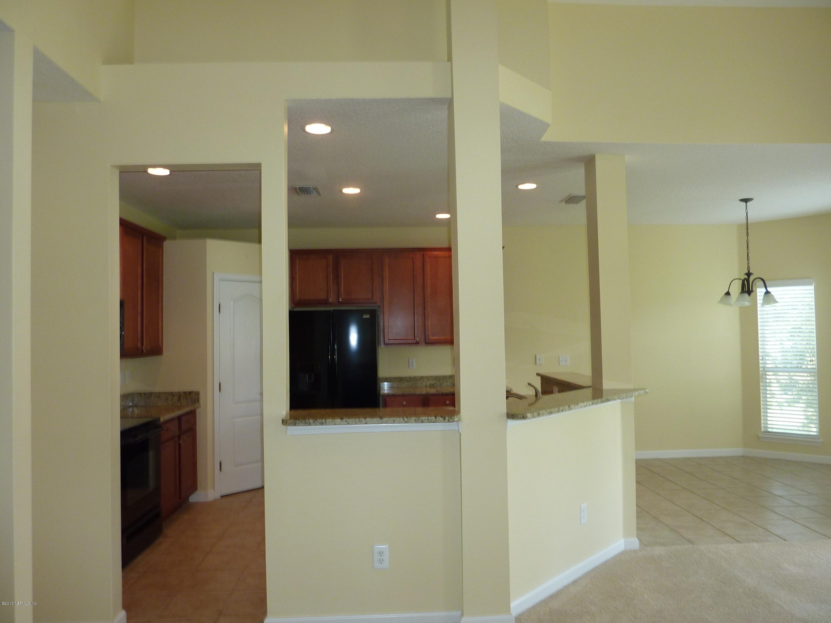 273 Porta Rosa Circle St. Augustine, FL 32092 - Photo 10 of 48 a view of a kitchen with a sink and a refrigerator