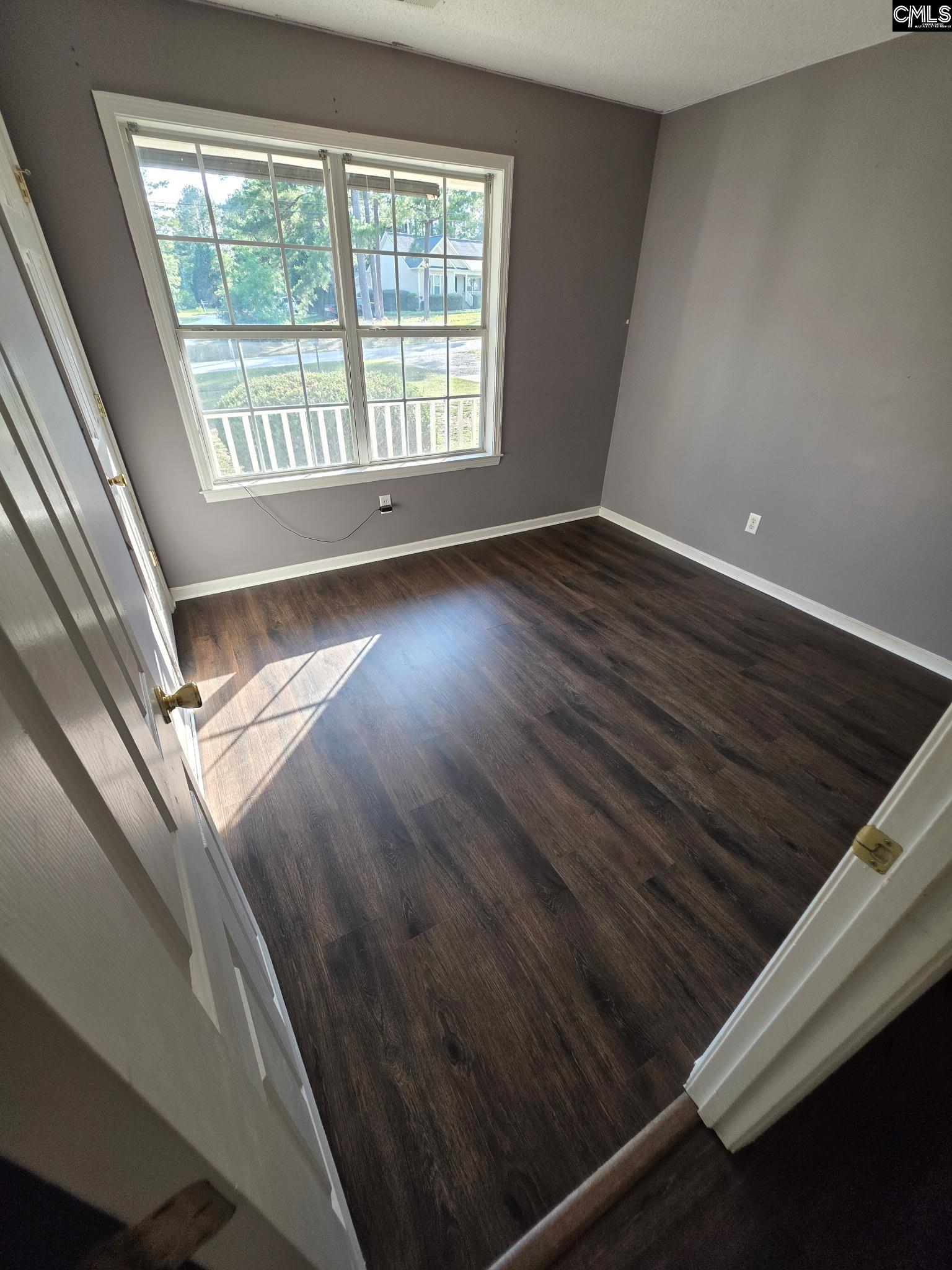 900 Watts Hill Road Lugoff, SC 29078 - Photo 17 of 33 a view of an empty room with wooden floor and a window