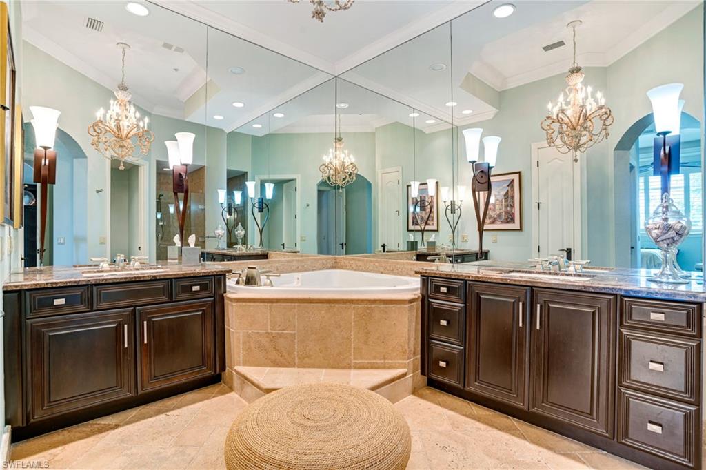 15547 Monterosso Lane, Unit 201 Naples, FL 34110 - Photo 18 of 50 a spacious bathroom with a sink vanity granite and a mirror