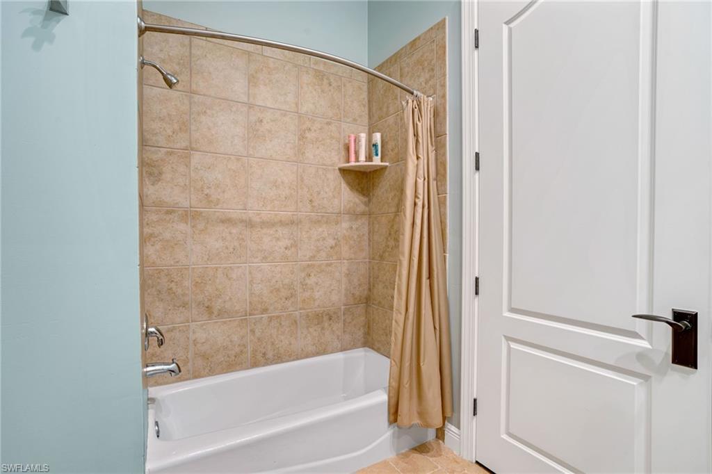 15547 Monterosso Lane, Unit 201 Naples, FL 34110 - Photo 22 of 50 a bathroom with a bathtub and a shower