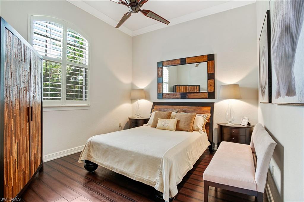 15547 Monterosso Lane, Unit 201 Naples, FL 34110 - Photo 23 of 50 a bedroom with a bed a mirror and a window