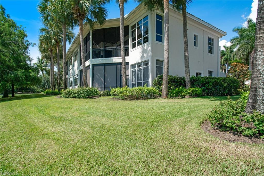 15547 Monterosso Lane, Unit 201 Naples, FL 34110 - Photo 29 of 50 a view of a building with a yard