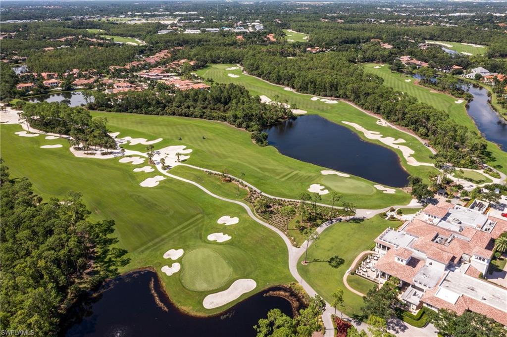 15547 Monterosso Lane, Unit 201 Naples, FL 34110 - Photo 36 of 50 an aerial view of a residential houses with outdoor space and trees