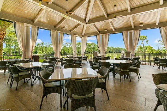 a dining room with lots of furniture and a chandelier