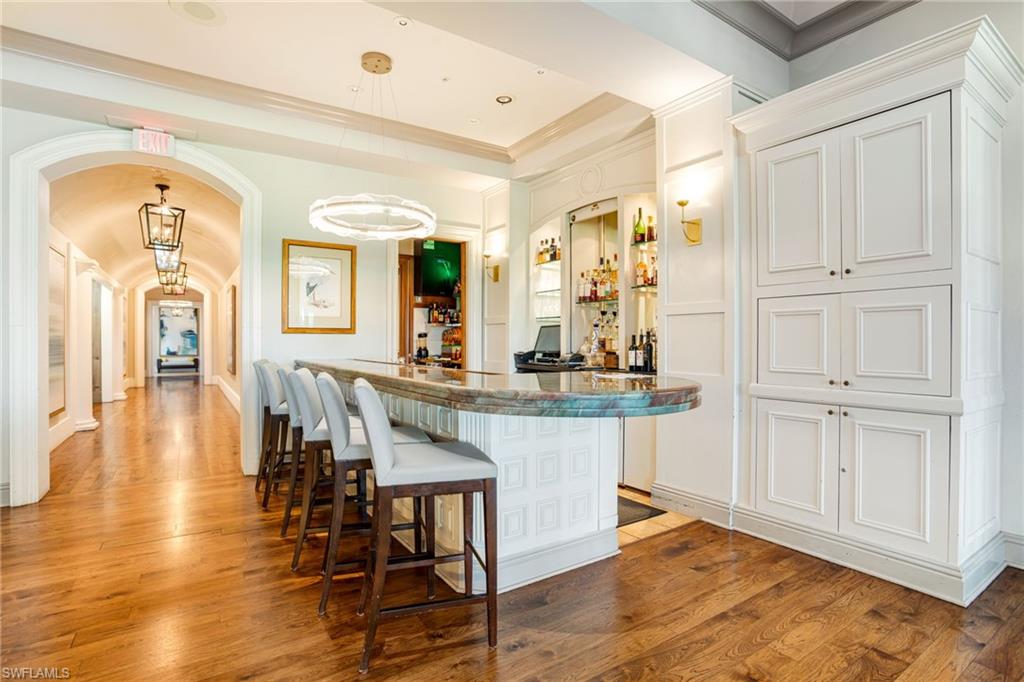 15547 Monterosso Lane, Unit 201 Naples, FL 34110 - Photo 42 of 50 a view of dining table chairs and wooden floor
