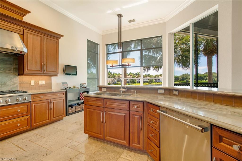 15547 Monterosso Lane, Unit 201 Naples, FL 34110 - Photo 5 of 50 a kitchen with stainless steel appliances granite countertop a sink and a stove