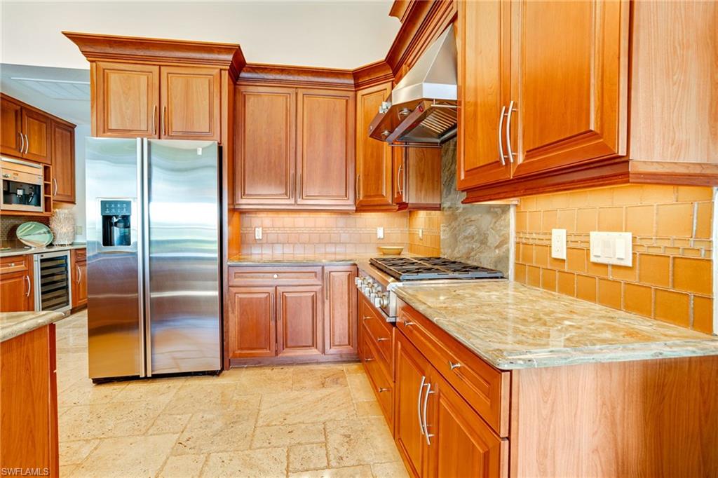 15547 Monterosso Lane, Unit 201 Naples, FL 34110 - Photo 6 of 50 a kitchen with stainless steel appliances granite countertop a sink and a refrigerator