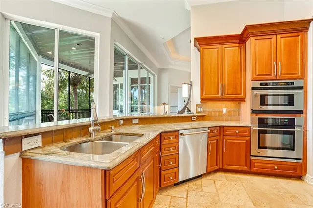 a kitchen with stainless steel appliances granite countertop a sink and a microwave