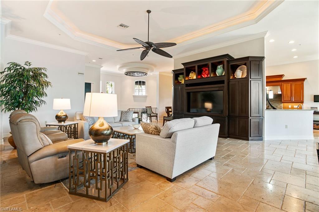15547 Monterosso Lane, Unit 201 Naples, FL 34110 - Photo 10 of 50 a living room with furniture a ceiling fan and a window