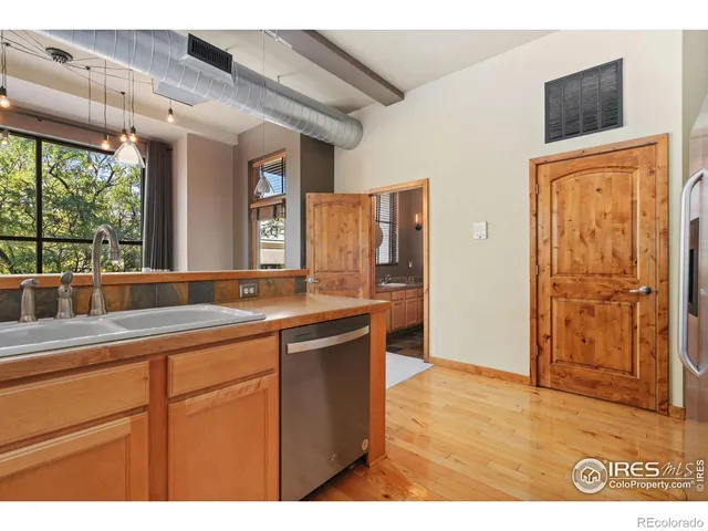 a kitchen with a sink and wooden cabinets