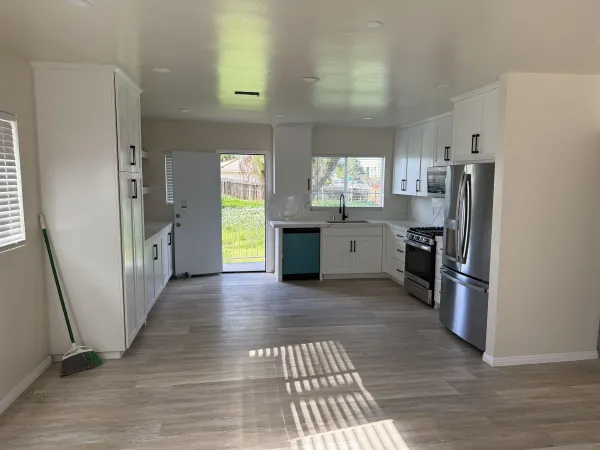 a kitchen with stainless steel appliances a stove a refrigerator and a sink