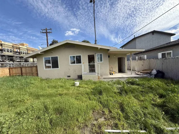 a view of a house with a yard and plants