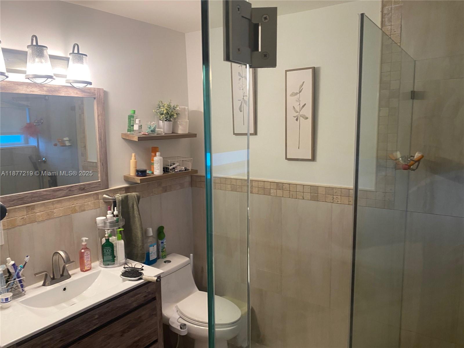 9203 Southwest 136th Terrace Miami, FL 33176 - Photo 13 of 22 a bathroom with a sink a toilet and shower