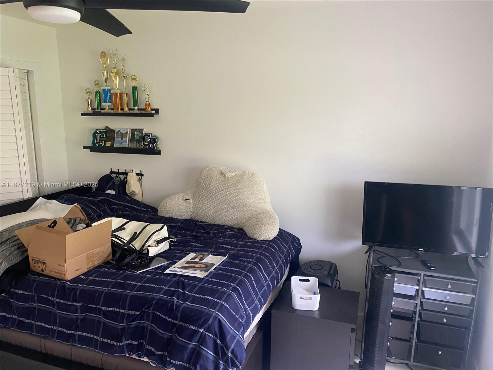 9203 Southwest 136th Terrace Miami, FL 33176 - Photo 15 of 22 a bedroom with a bed and a flat screen tv