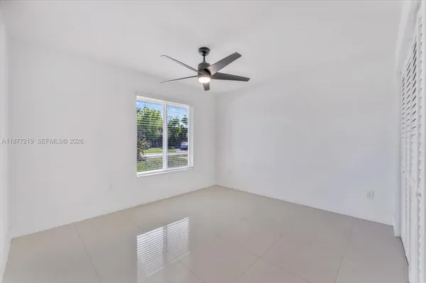 a view of a big room with wooden floor and windows in a room