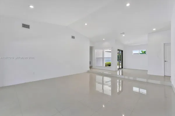 a view of an empty room with glass door