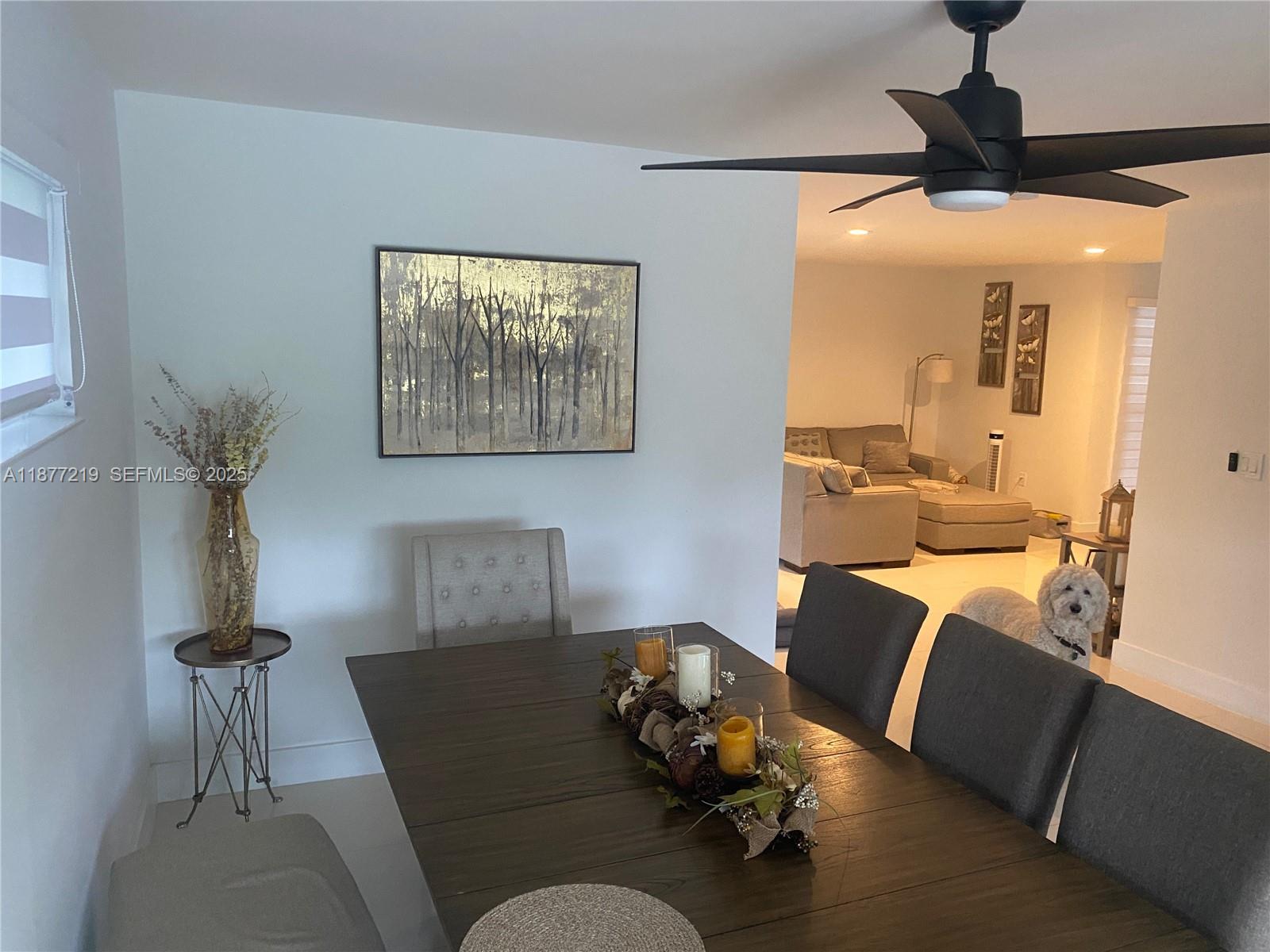 9203 Southwest 136th Terrace Miami, FL 33176 - Photo 8 of 22 a living room with furniture and a chandelier