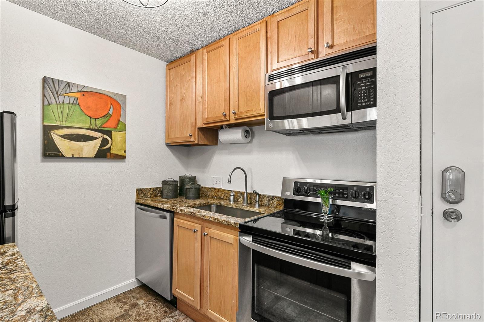 3250 Oneal Circle, Unit 17 Boulder, CO 80301 - Photo 11 of 29 a kitchen with stainless steel appliances granite countertop a stove and a microwave