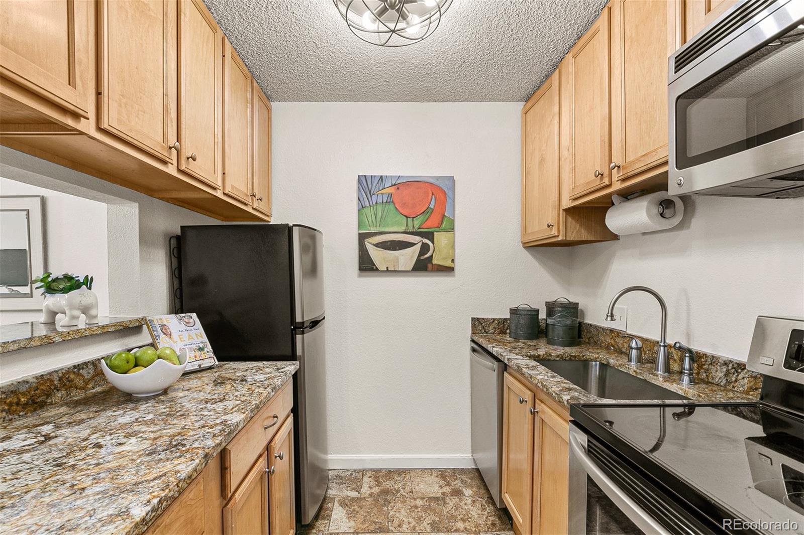 3250 Oneal Circle, Unit 17 Boulder, CO 80301 - Photo 13 of 29 a kitchen with stainless steel appliances granite countertop a sink stove and refrigerator