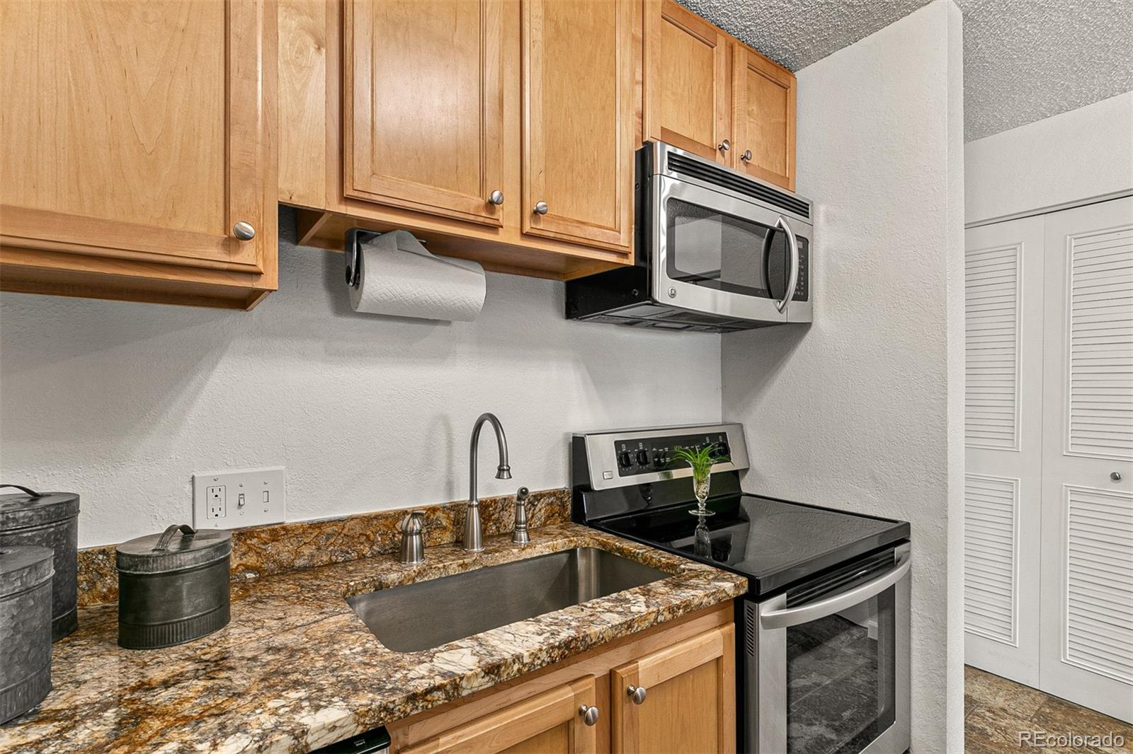 3250 Oneal Circle, Unit 17 Boulder, CO 80301 - Photo 14 of 29 a kitchen with stainless steel appliances granite countertop a sink a stove and cabinets