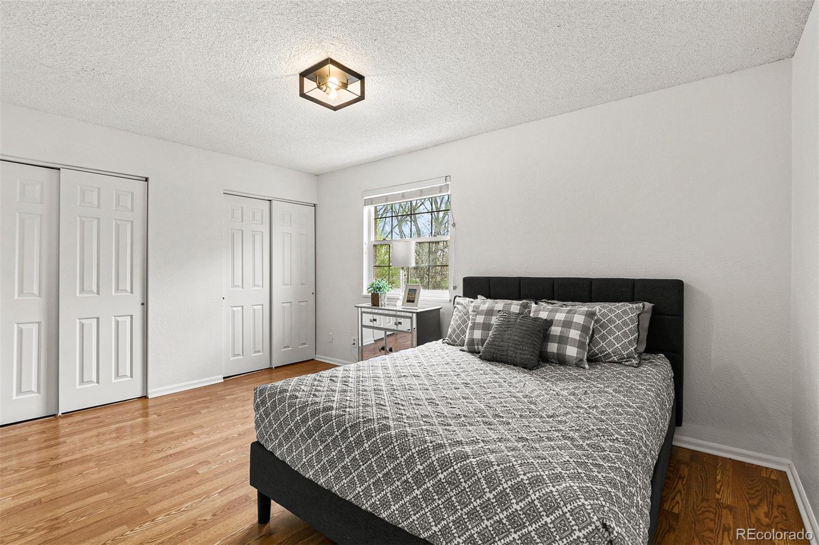 3250 Oneal Circle, Unit 17 Boulder, CO 80301 - Photo 16 of 29 a bedroom with a bed and wooden floor