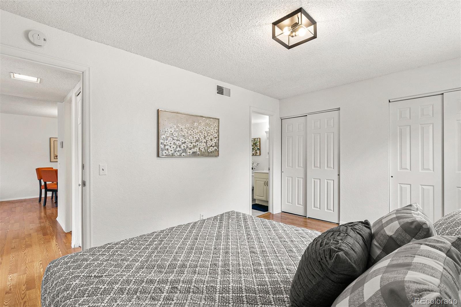 3250 Oneal Circle, Unit 17 Boulder, CO 80301 - Photo 19 of 29 a bedroom with a bed and a chandelier