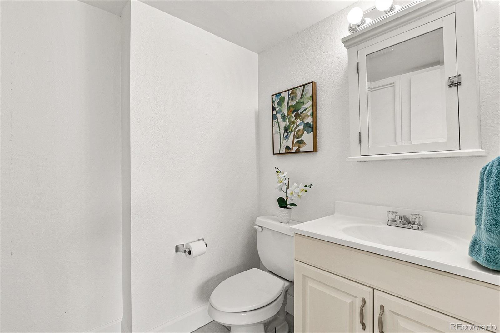 3250 Oneal Circle, Unit 17 Boulder, CO 80301 - Photo 20 of 29 a bathroom with a sink mirror vanity and toilet