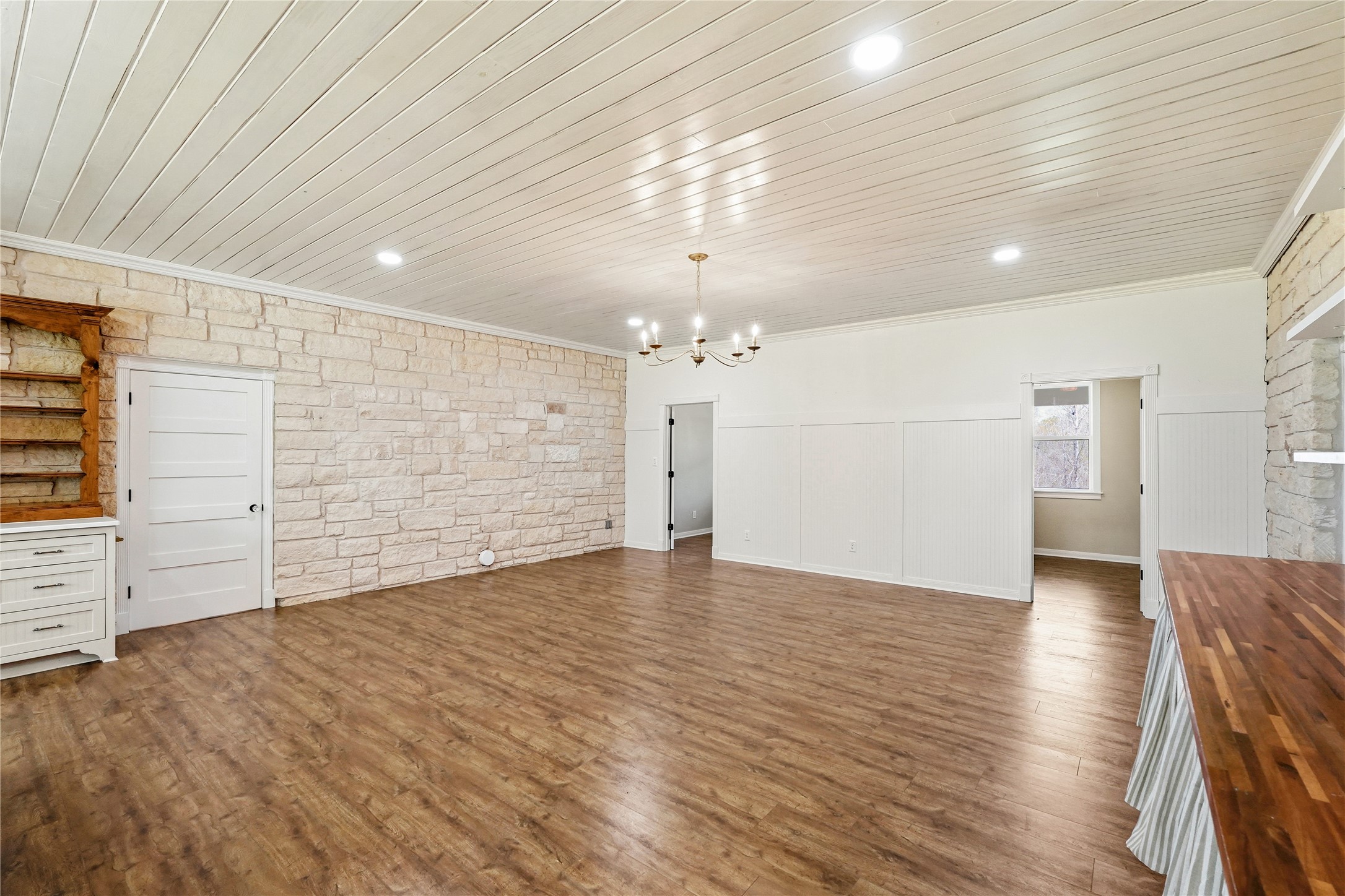 41712 Harpers Church Road Hempstead, TX 77445 - Photo 13 of 50 View to large dining/entertainment area within Cottage/Vintage Kitchen number 2, and entrance to 1 bedroom and one Flex room space, doorway leading to main living area, Gorgeous Austin Stone, Bead board Ceiling, wood floors