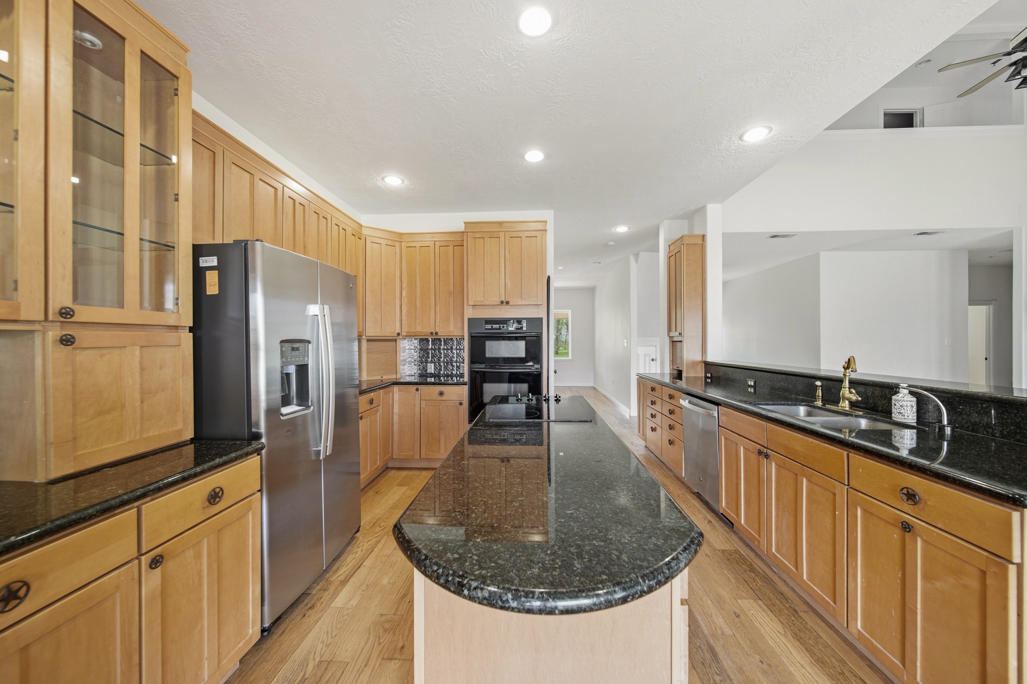 41712 Harpers Church Road Hempstead, TX 77445 - Photo 20 of 50 Texas themed Kitchen number 1 open to main living area, Granite countertops and decorative tin backsplash, large island, Deep sink, walk in pantry and plenty of storage