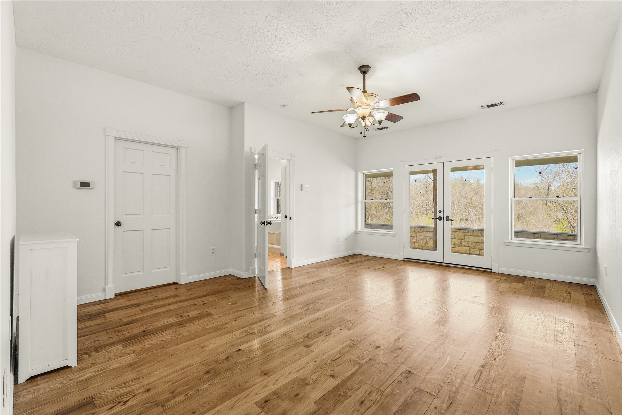 41712 Harpers Church Road Hempstead, TX 77445 - Photo 27 of 50 Primary Suite w/French doors to patio,wood floors