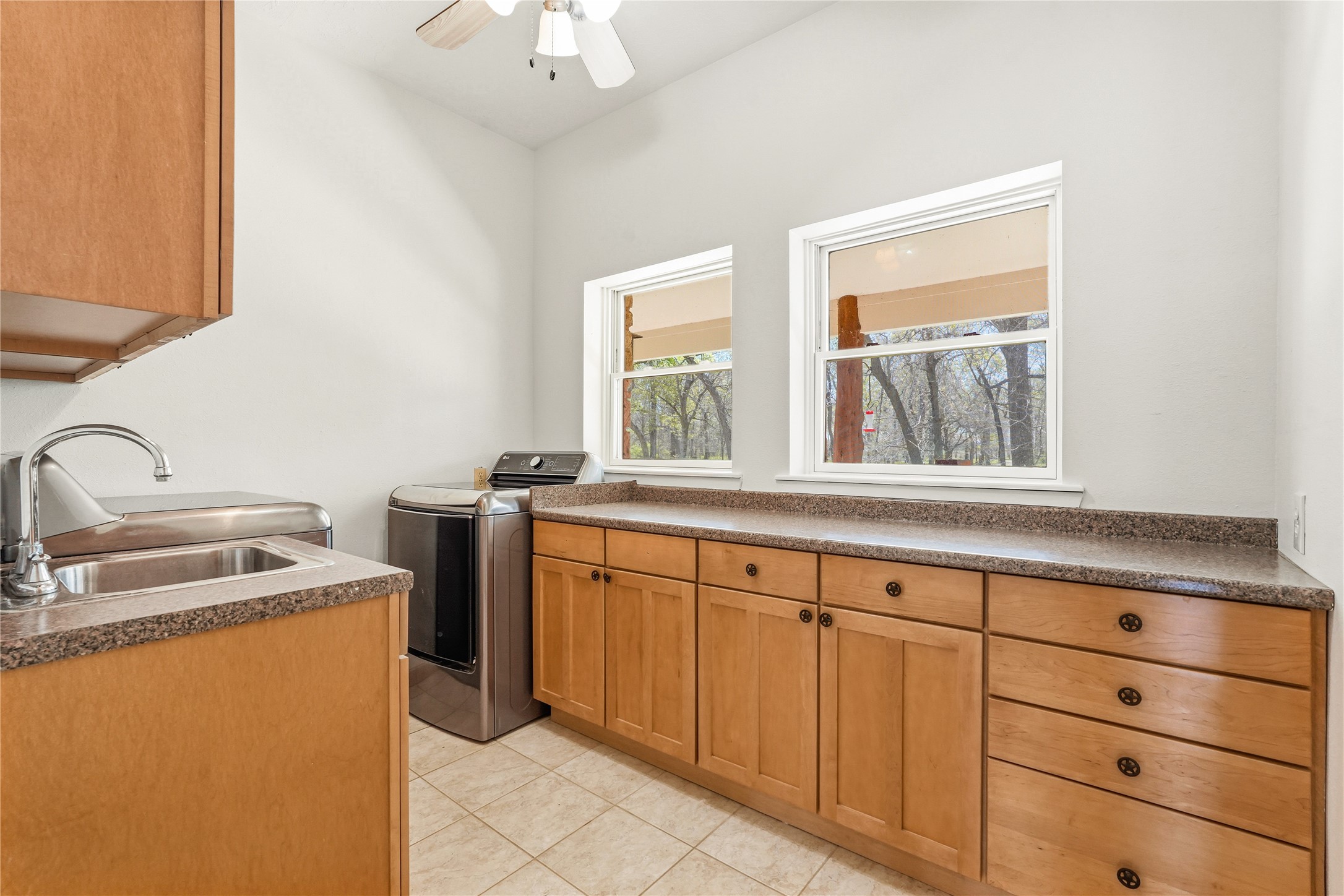 41712 Harpers Church Road Hempstead, TX 77445 - Photo 32 of 50 Utility room no 1 with shelving, deep sink, additional storage and views to front porch w numerous trees