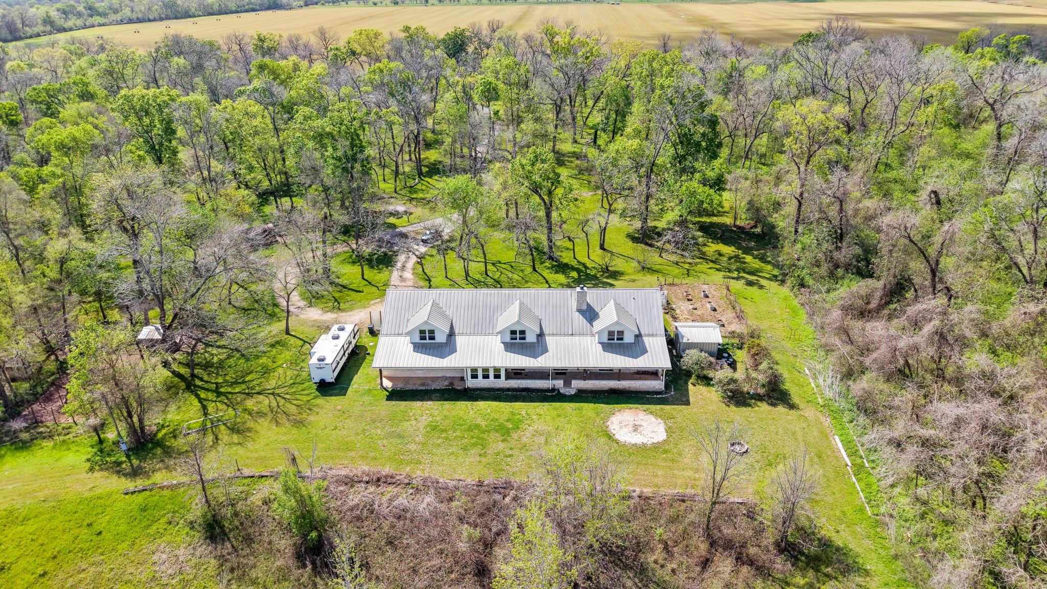 41712 Harpers Church Road Hempstead, TX 77445 - Photo 48 of 50 Aerial view of the backside of the home, 2 porches, firepit, lg garden, to the left is livestock pens, and chicken coop