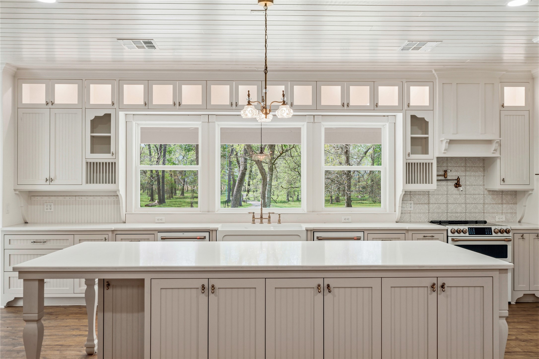 41712 Harpers Church Road Hempstead, TX 77445 - Photo 8 of 50 32x22 Cottage /Vintage Kitchen number 2, 10x5 functional Island with sit up custom storage for appliances and lg pots and pans, Gleaming Quartz counter tops, Views to front porch and treed driveway, custom cabinets and soft close drawers, 2 dishwashers, deep sink, pot filler, CAFE appliances,2 pantry's, bead board ceiling, Vintage lighting, upper lit display storage