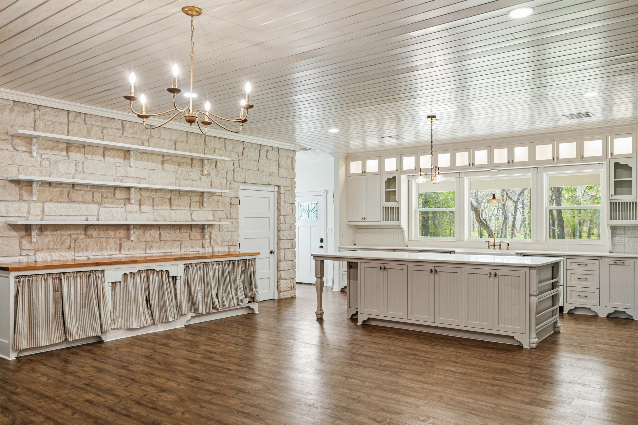 41712 Harpers Church Road Hempstead, TX 77445 - Photo 9 of 50 Kitchen number 2 shelving and extra storage,shelving, lit display cabinets, wood flooring, bead board ceiling, door leading to 5 ft wide stairway up to Gameroom, Gorgeous Austin Stone, Vintage Lighting