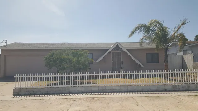 a view of a house with a fence