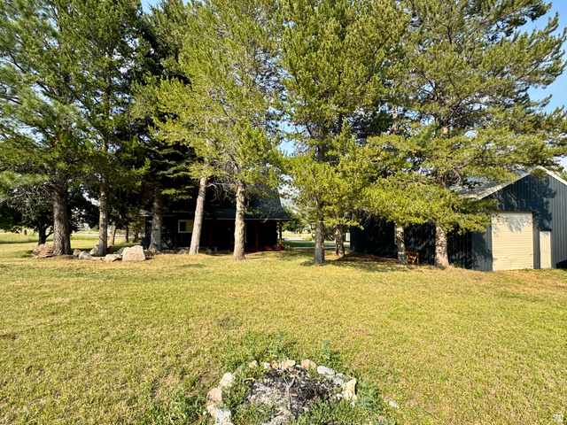 2807 North Ogden Canyon Road Eden, UT 84310 - Photo 72 of 72 Expansive lawn area featuring a rock-lined fire pit