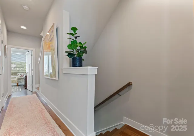 a hallway with front door and wooden floor
