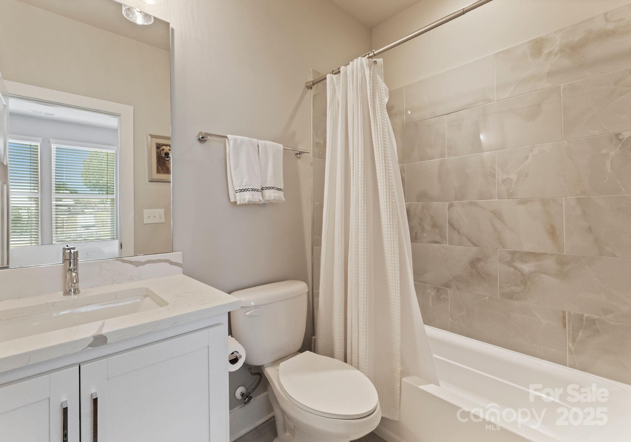 2111 Isom Street Charlotte, NC 28208 - Photo 25 of 36 a bathroom with a sink toilet and shower