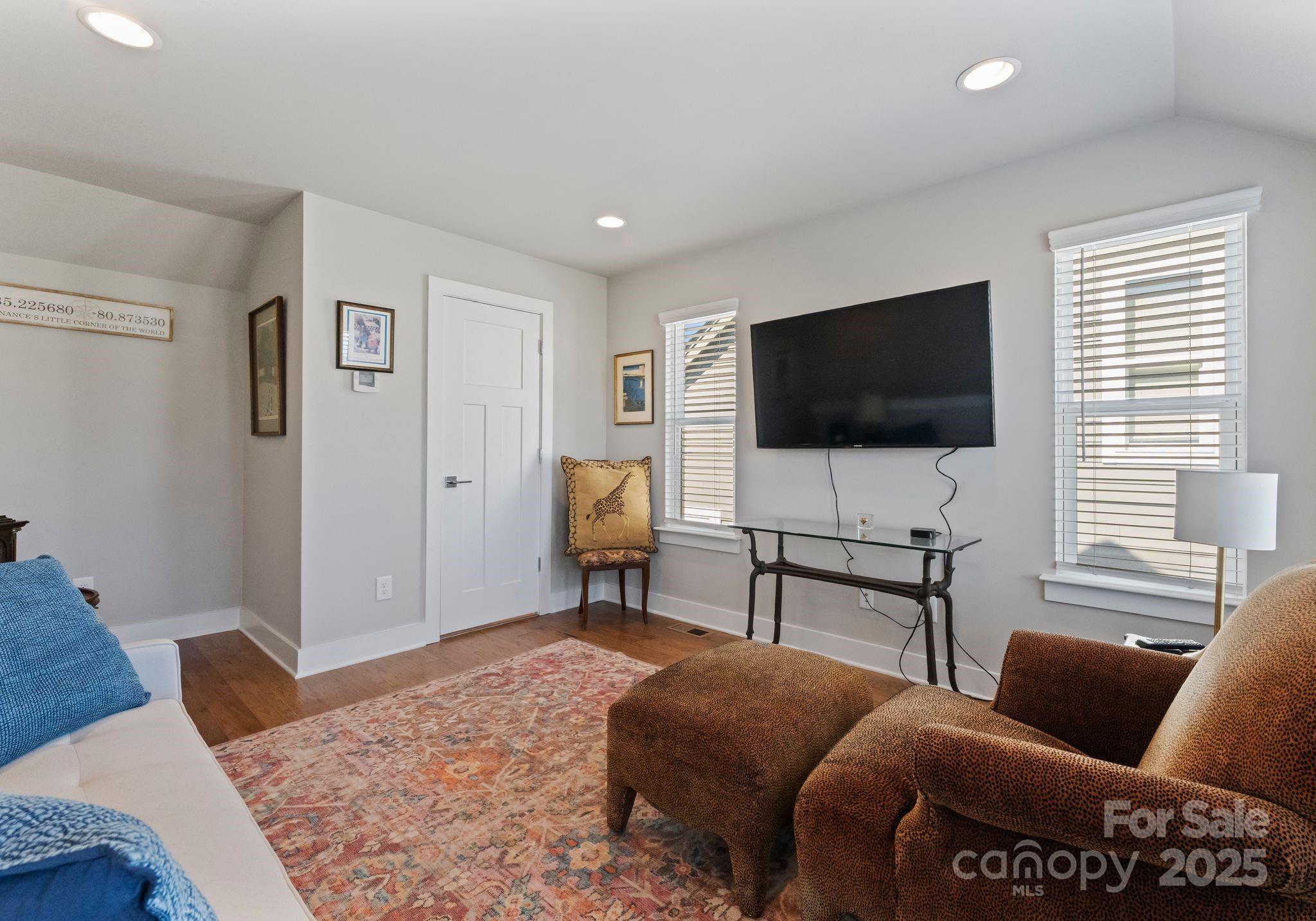 2111 Isom Street Charlotte, NC 28208 - Photo 27 of 36 a living room with furniture and a flat screen tv
