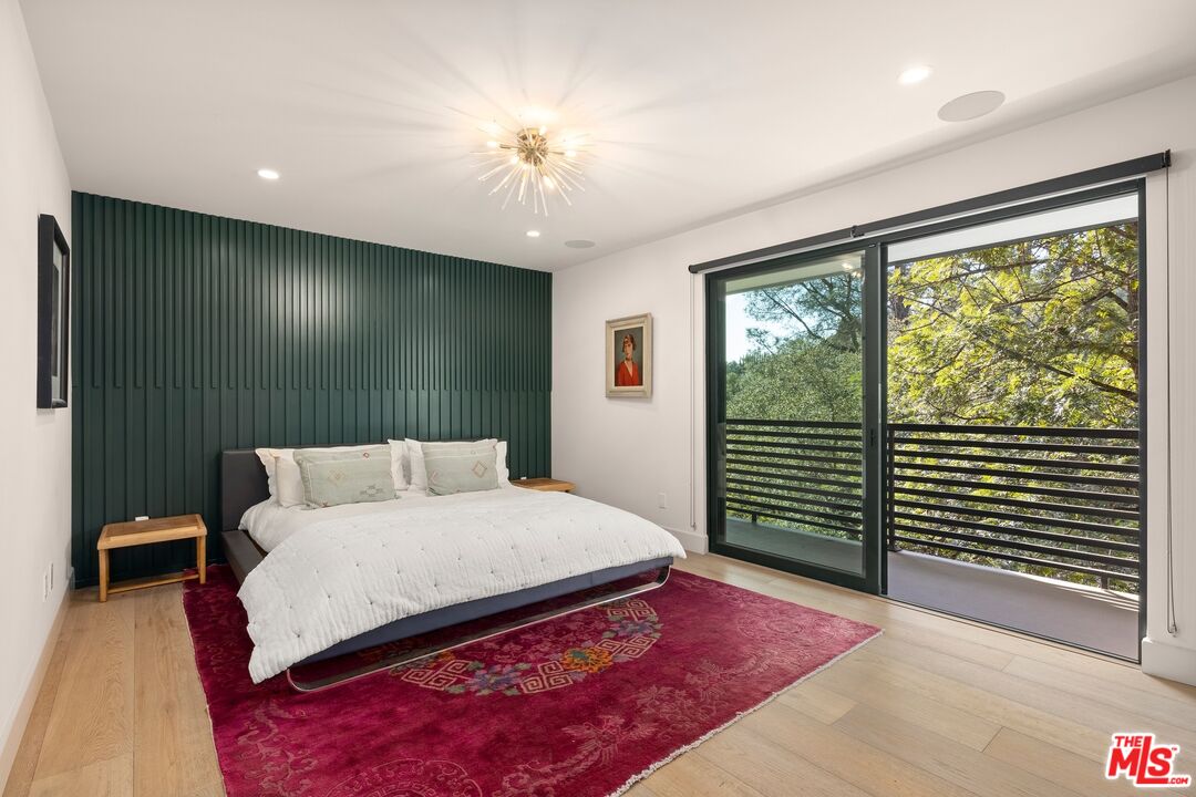 3147 Hollyridge Drive Los Angeles, CA 90068 - Photo 9 of 14 a bedroom with a large bed and a window
