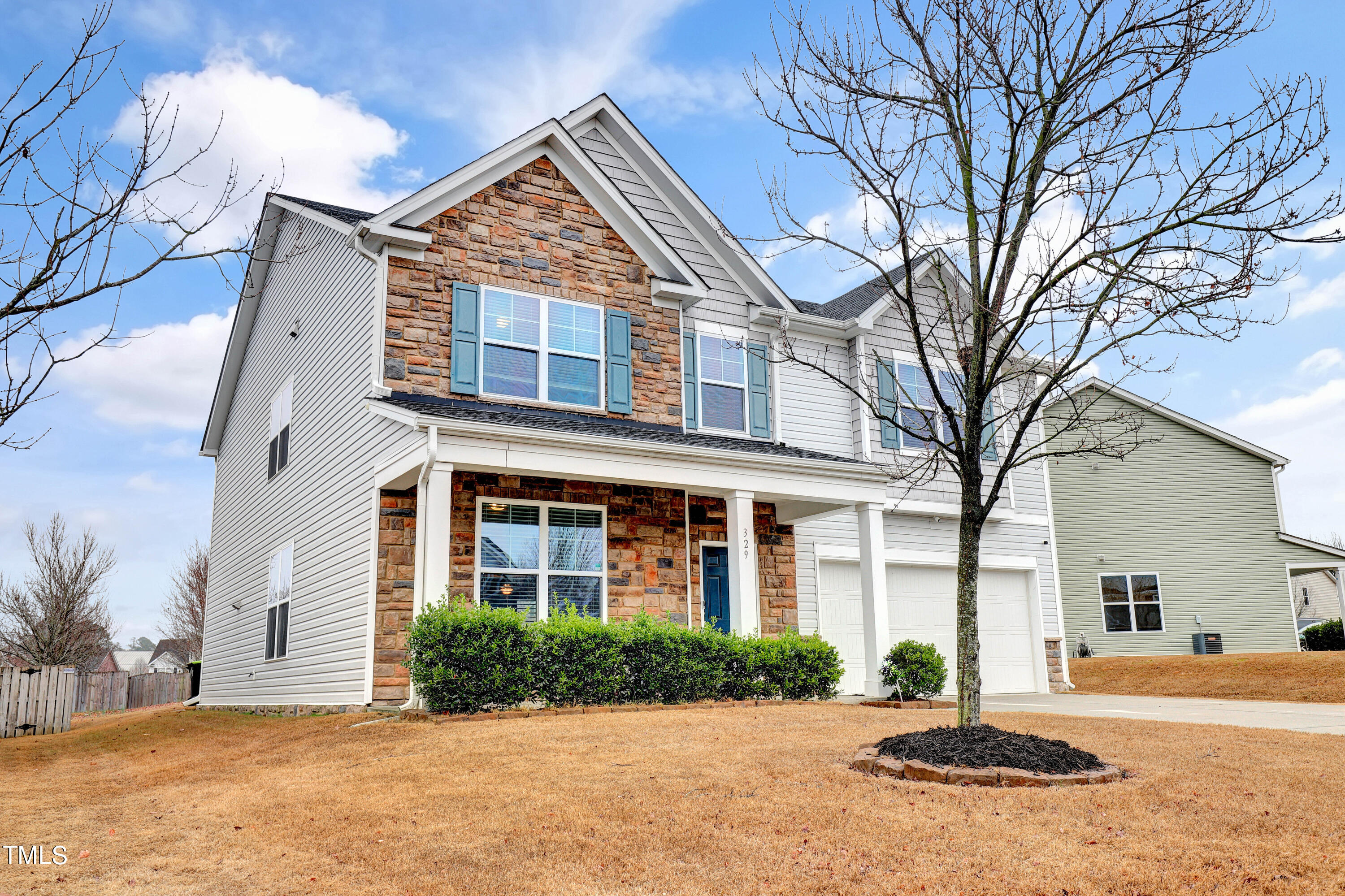 329 Hope Valley Road Knightdale, NC 27545 - Photo 2 of 34 a front view of a house with a yard and garage