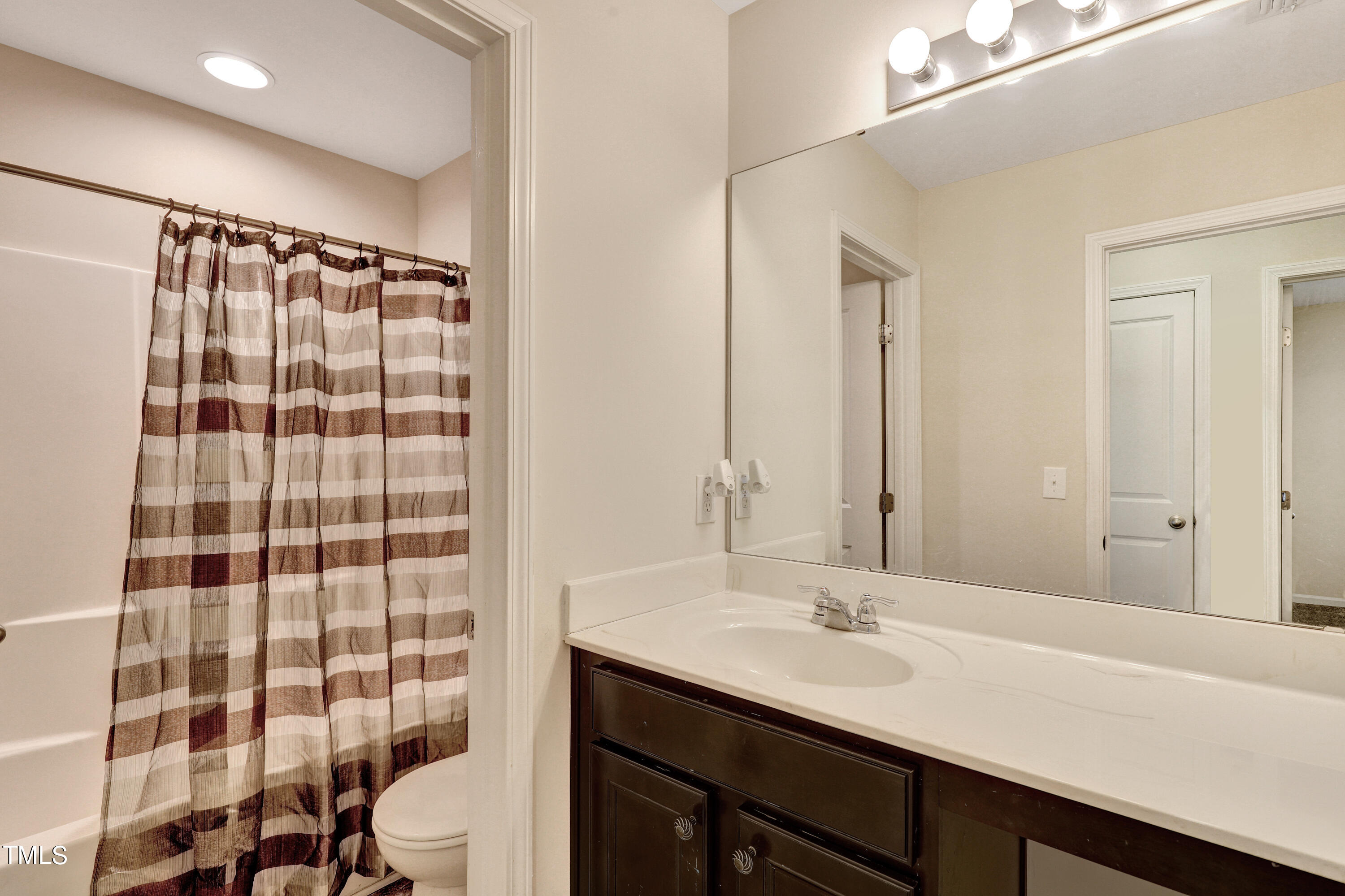 329 Hope Valley Road Knightdale, NC 27545 - Photo 31 of 34 a bathroom with a sink a toilet a shower and a mirror
