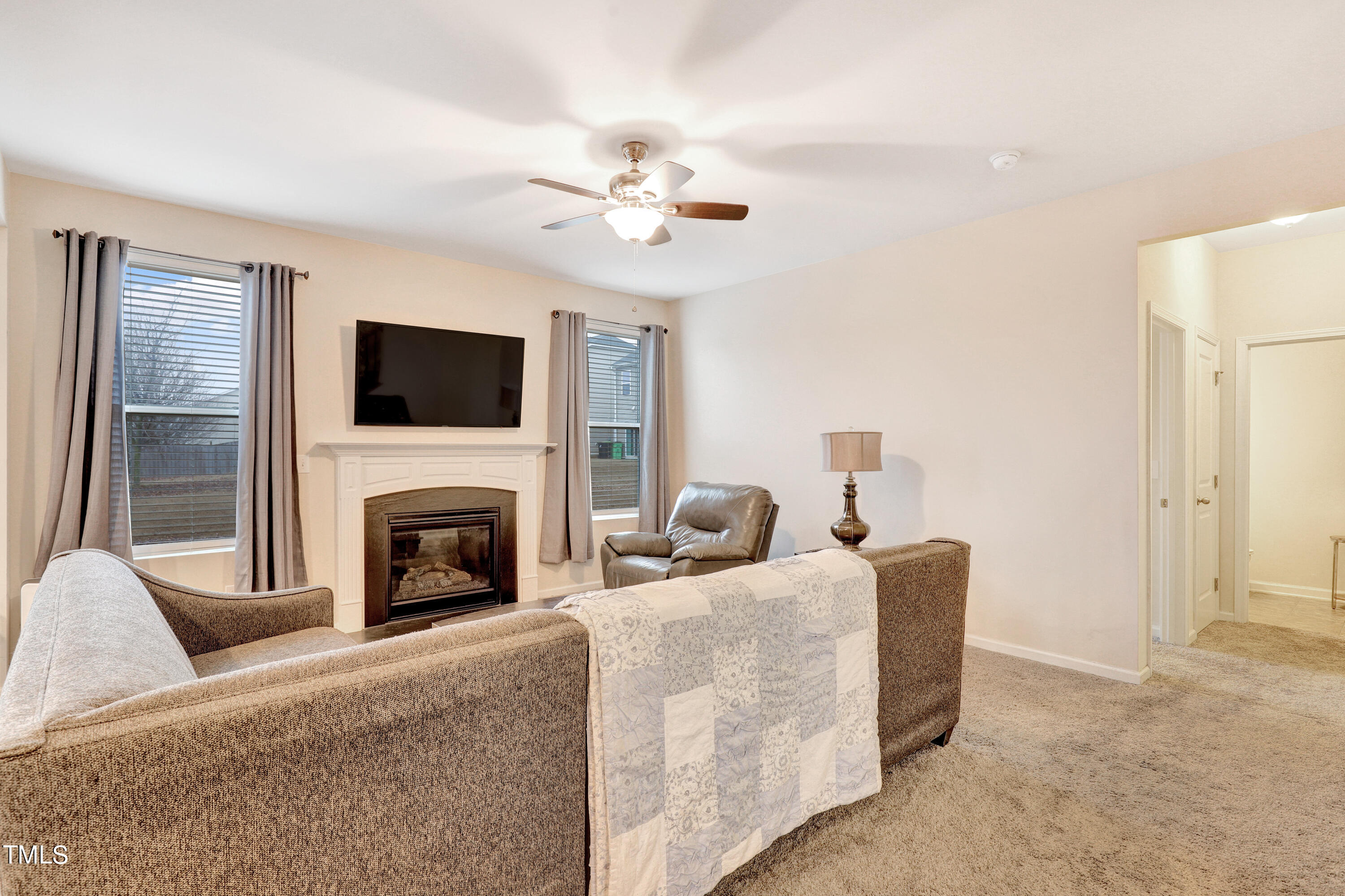 329 Hope Valley Road Knightdale, NC 27545 - Photo 7 of 34 a living room with furniture a fireplace and a flat screen tv