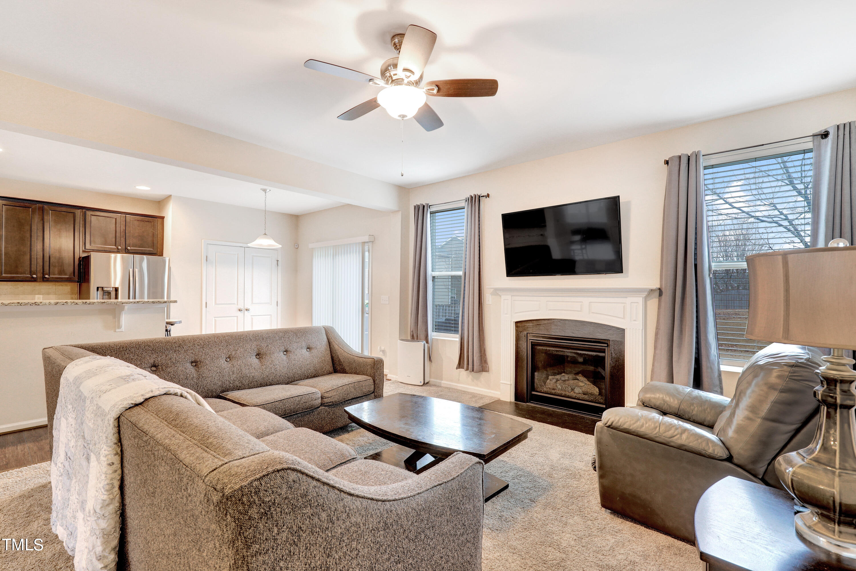329 Hope Valley Road Knightdale, NC 27545 - Photo 8 of 34 a living room with furniture flat screen tv and a fireplace