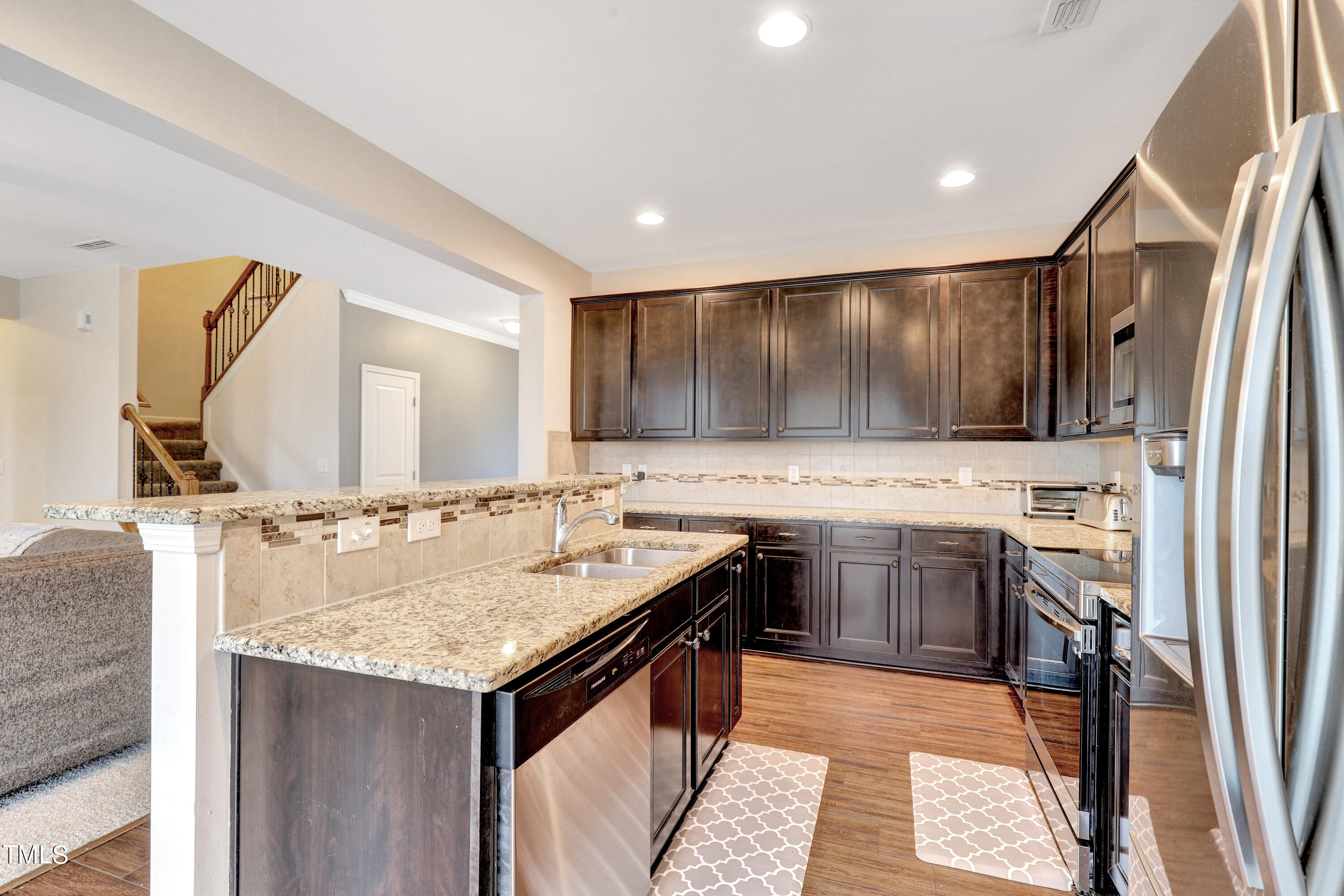 329 Hope Valley Road Knightdale, NC 27545 - Photo 9 of 34 a kitchen with a sink refrigerator and microwave